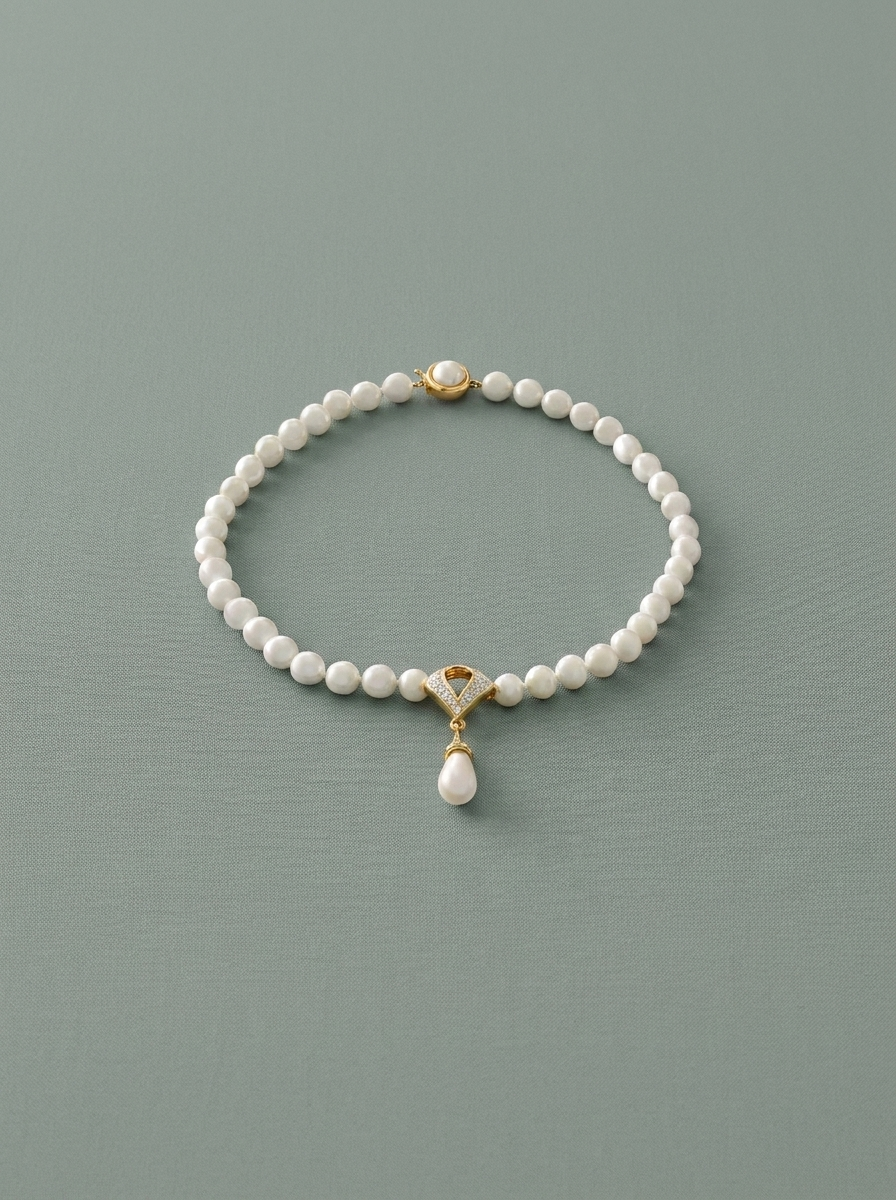 Pearl and cubic zirconia necklace with a teardrop pearl at the centre