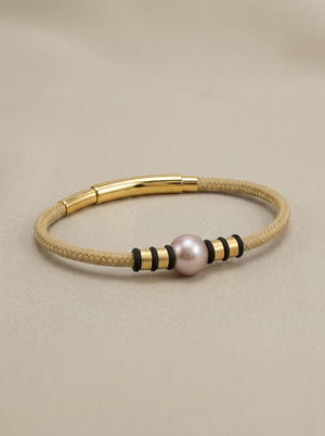 Beige cord bracelet with a copper pearl
