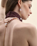 Model wearing a long cultured pearl necklace