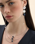 Model wearing a silver chain necklace with a black pearl