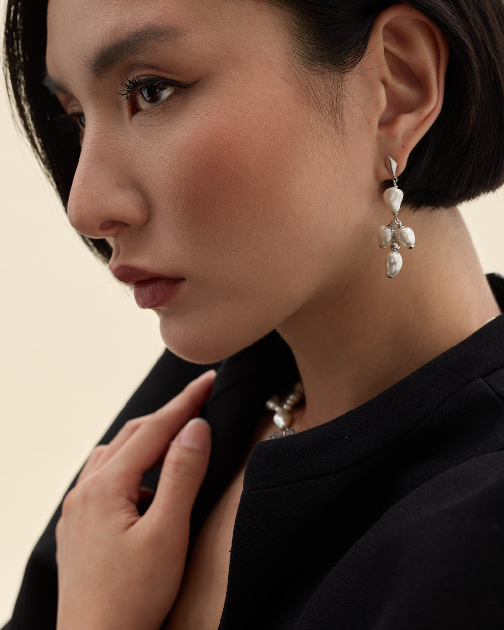 modelo con pendientes de forma geometrica de plata y perla barroca de Mallorca