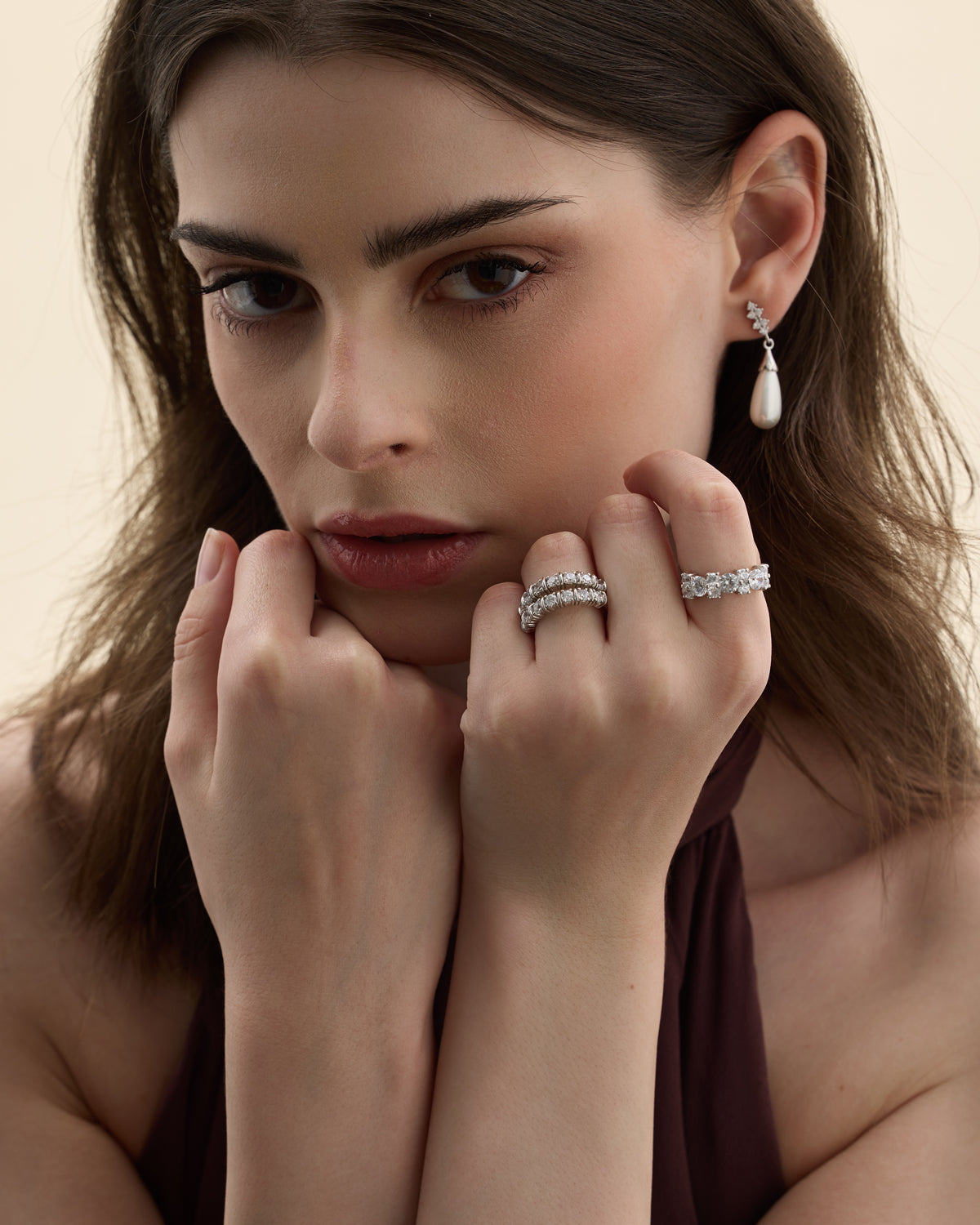 Model wearing cubic zirconia rings in silver and gold tones