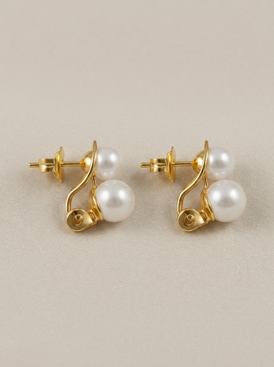 Omega-back earrings with two pearls in different sizes