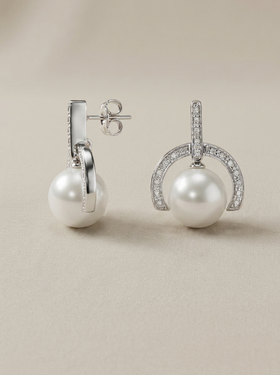 Drop earrings with a pearl and a semicircular silver and cubic zirconia setting