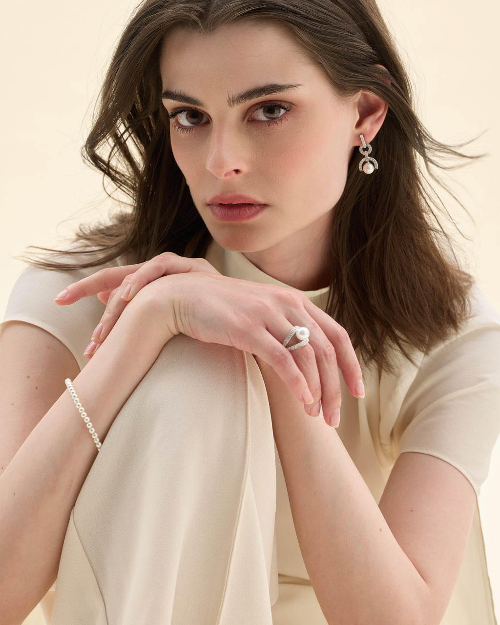 Model wearing a pearl earrings, rings and necklace set