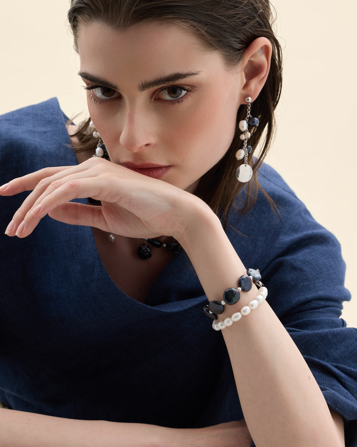 Model wearing a matching cultured pearl necklace and drop earrings set